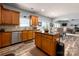 Bright kitchen with wooden cabinets, stainless steel appliances, granite countertops, and tile backsplash at 8909 Savannah Rd, Harrisburg, NC 28075