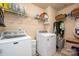 Efficient laundry room equipped with modern washer and dryer, plus ample shelving for storage at 8909 Savannah Rd, Harrisburg, NC 28075