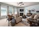 Inviting living room featuring a fireplace, ceiling fan, neutral paint, and comfortable seating arrangement at 8909 Savannah Rd, Harrisburg, NC 28075