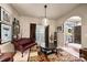 Comfortable living room with a decorative chandelier, stylish seating, and ample natural light at 8909 Savannah Rd, Harrisburg, NC 28075