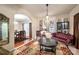 Bright living room with a decorative chandelier, comfortable seating, and seamless flow to the dining area at 8909 Savannah Rd, Harrisburg, NC 28075