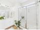 Bright bathroom featuring a glass shower door and a white vanity with storage at 9030 Gander Dr, Charlotte, NC 28277