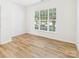 Inviting bedroom with a large window offering natural light, showcasing the laminate flooring and neutral walls at 9030 Gander Dr, Charlotte, NC 28277