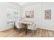 Well-lit dining room features laminate floors, a modern chandelier, and neutral decor at 9030 Gander Dr, Charlotte, NC 28277