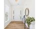 Bright entryway with new laminate flooring, a plant, a large mirror and a white front door at 9030 Gander Dr, Charlotte, NC 28277