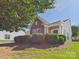 This home features a well-kept lawn, neutral siding and a stacked stone accent wall at 9030 Gander Dr, Charlotte, NC 28277