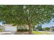 Charming home with a well-manicured front yard and beautiful, mature tree providing plenty of shade on a sunny day at 9030 Gander Dr, Charlotte, NC 28277
