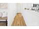Inviting hallway with wood-look floors, white walls, and access to other rooms at 9030 Gander Dr, Charlotte, NC 28277