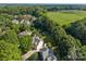 Drone shot of home surrounded by large green trees and shrubbery, featuring a well maintained lawn at 9038 Sandpiper Dr, Charlotte, NC 28277