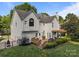 Spacious backyard with a wooden deck, pergola, manicured landscaping, and black metal fencing at 9038 Sandpiper Dr, Charlotte, NC 28277