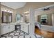 Well-appointed bathroom with double vanities, sleek mirrors, and a glimpse into the connected bedroom area at 9038 Sandpiper Dr, Charlotte, NC 28277
