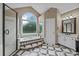 Elegant bathroom boasts a garden tub, black and white tile, and a large window for natural light at 9038 Sandpiper Dr, Charlotte, NC 28277