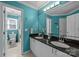 Stylish bathroom with double sinks, granite countertops, and bright turquoise walls for a refreshing ambiance at 9038 Sandpiper Dr, Charlotte, NC 28277
