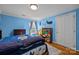 Bright bedroom with blue walls, playful decor, and a cozy, inviting atmosphere for rest and play at 9038 Sandpiper Dr, Charlotte, NC 28277