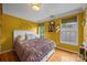 Bright bedroom with hardwood floors, a cozy bed, and multiple windows at 9038 Sandpiper Dr, Charlotte, NC 28277