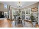 Bright breakfast nook features a glass table, chandelier, and views from large windows with tile floors and a fireplace at 9038 Sandpiper Dr, Charlotte, NC 28277