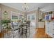 Inviting breakfast nook featuring a glass table, bright windows, and stylish chandelier at 9038 Sandpiper Dr, Charlotte, NC 28277