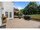 Expansive deck with outdoor seating, grill, and lush greenery offers a perfect space for outdoor entertaining at 9038 Sandpiper Dr, Charlotte, NC 28277
