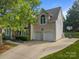 Two-story home with two-car garage, basketball hoop, and well-maintained landscaping at 9038 Sandpiper Dr, Charlotte, NC 28277