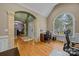 Elegant foyer with hardwood floors, an arched doorway, and a large window that provides natural light at 9038 Sandpiper Dr, Charlotte, NC 28277