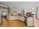 Open-concept kitchen with a breakfast bar, stainless steel appliances, and hardwood floors at 9038 Sandpiper Dr, Charlotte, NC 28277