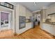 Spacious kitchen with stainless steel appliances, custom cabinetry, hardwood floors, and modern lighting at 9038 Sandpiper Dr, Charlotte, NC 28277