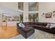 Inviting living room with hardwood floors, large sectional, and open layout connecting to the kitchen at 9038 Sandpiper Dr, Charlotte, NC 28277