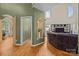 Bright living room featuring hardwood floors, an elegant archway, and views into the adjacent office space at 9038 Sandpiper Dr, Charlotte, NC 28277