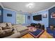 Comfortable living room features a plush sofa, entertainment center, and sports-themed decor for relaxation at 9038 Sandpiper Dr, Charlotte, NC 28277