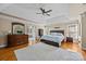 Spacious main bedroom with tray ceiling, hardwood floors, and plenty of natural light, creating a peaceful retreat at 9038 Sandpiper Dr, Charlotte, NC 28277