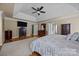 Large main bedroom featuring a tray ceiling, hardwood floors, and ample space for relaxation and rest at 9038 Sandpiper Dr, Charlotte, NC 28277
