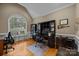 Office featuring hardwood floors, a vaulted ceiling with a large arched window, and a built-in desk at 9038 Sandpiper Dr, Charlotte, NC 28277