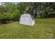 Backyard features a well-maintained storage shed for lawn equipment and garden tools at 9038 Sandpiper Dr, Charlotte, NC 28277
