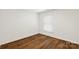 Bright, minimalist bedroom with wood-look floors and a large window at 922 Maurice St, Monroe, NC 28112