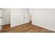 Neutral bedroom featuring wood-look floors and a door to a walk-in closet at 922 Maurice St, Monroe, NC 28112