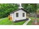 Side view of a charming home with fresh exterior paint, black trim, and a sidewalk at 922 Maurice St, Monroe, NC 28112