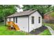Rear view of a charming home with fresh exterior paint, black trim, and a wooden deck at 922 Maurice St, Monroe, NC 28112