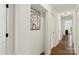 Hallway featuring wood-look flooring, white walls, and natural light at 922 Maurice St, Monroe, NC 28112