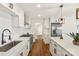 Bright kitchen featuring white cabinets, stainless steel appliances, an island with a sink, and wood flooring at 922 Maurice St, Monroe, NC 28112