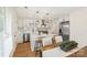 Modern white kitchen featuring stainless steel appliances, a central island, and wooden breakfast bar stools at 922 Maurice St, Monroe, NC 28112