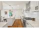 Modern kitchen with stainless steel appliances, white cabinetry, an island, and wood floors at 922 Maurice St, Monroe, NC 28112