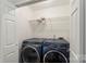 Convenient laundry room with modern washer and dryer units, and a wire shelf for storage at 922 Maurice St, Monroe, NC 28112