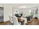 Open dining and living area with a modern light fixture, white walls, and wood floors at 922 Maurice St, Monroe, NC 28112