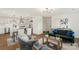 Bright living room with modern decor, wood floors, and open concept to the kitchen and dining area at 922 Maurice St, Monroe, NC 28112