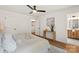 Comfortable primary bedroom featuring a ceiling fan, wood-look floors, and ensuite bath at 922 Maurice St, Monroe, NC 28112