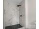 Close up of stylish shower featuring black fixtures and marble-look tile at 922 Maurice St, Monroe, NC 28112