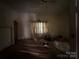 Bedroom with ceiling fan and window, showing signs of neglect and repair at 0 Woodleaf Rd, Salisbury, NC 28147