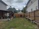 Spacious backyard with a wooden fence, patio area, and ample space for outdoor activities at 1017 W C St, Kannapolis, NC 28081