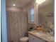 Bright bathroom featuring a granite countertop, ample lighting, and a butterfly-themed shower curtain at 1017 W C St, Kannapolis, NC 28081