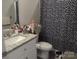 Bathroom showcasing a vanity with granite countertop, toilet, and a blue and white floral shower curtain at 1017 W C St, Kannapolis, NC 28081